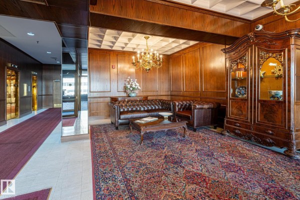 Mailroom with mailboxes, wooden paneling, and access to the outside. - #602 11503 100 Av Nw, Edmonton