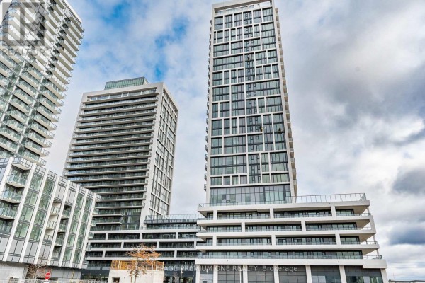 View looking up at tall modern condo buildings with glass balconies. - 604 - 8960 Jane Street, Vaughan