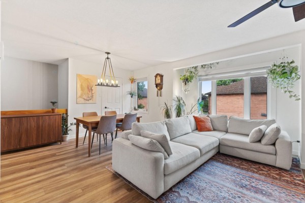 Open-concept living and dining area with large sectional couch and wooden dining set. - 604 Boul. Des Hautes-plaines, Gatineau