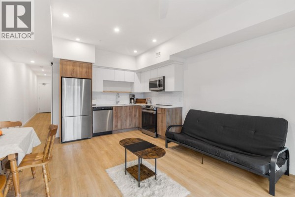 Kitchen area featuring stainless steel appliances and a black futon - 604 Cawston Avenue Unit# 404, Kelowna