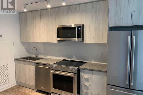 Compact kitchen with light wood cabinets, stainless steel appliances, and granite countertops. - 605 - 621 Sheppard Avenue E, Toronto