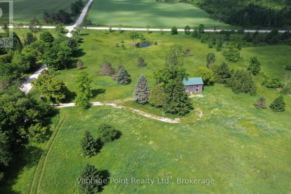 Overhead shot of a small barn or shed in a grassy field with trees. - 605303 13a Side Road, Grey Highlands