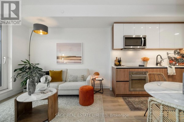 Dining area with a marble table and wicker chairs, next to a modern shower stall. - 606 - 150 Logan Avenue, Toronto