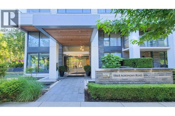 Building entrance with modern design, stone facade, landscaping, and water feature. - 606 5868 Agronomy Road, Vancouver