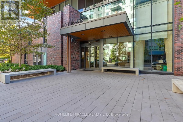 Entrance to the apartment building at 20 Tubman Avenue with brick and glass facade. - 607 - 20 Tubman Avenue, Toronto