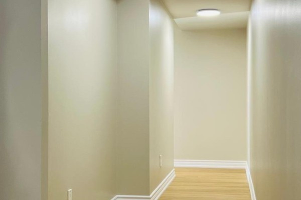 Interior hallway with neutral beige walls, white baseboards, and light wood flooring. - 607 - 4090 Living Arts Drive, Mississauga