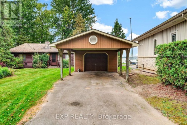 Close-up of the detached garage and carport attached to the cottage. - 607 Duclos Point Road, Georgina