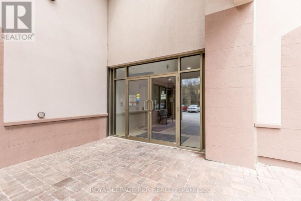 Lobby area with a round table, plants, and tile flooring. - 608 - 699 Aberdeen Boulevard, Midland
