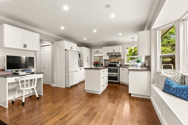 Overhead view of the foyer, showing a curved white wooden staircase, double front doors, and entrance to living areas. - 6089 185 Street, Surrey