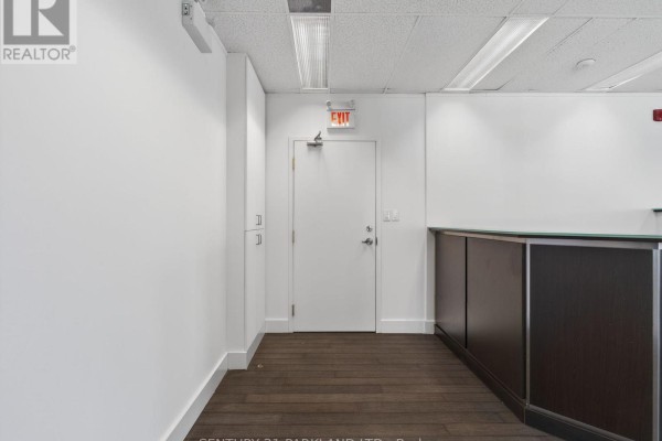 Interior hallway with door to office and reception area - 609 - 220 Duncan Mill Road, Toronto