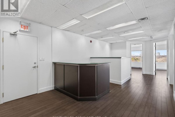 Spacious office layout with reception desk and large windows - 609 - 220 Duncan Mill Road, Toronto