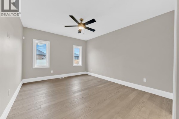 Bedroom with ceiling fan and hardwood floors - 61 Hilton Court Amherstburg
