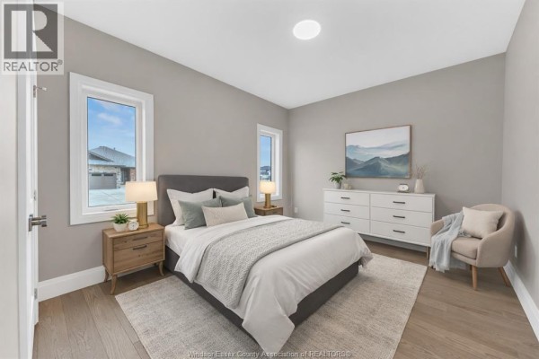 Bedroom with bed, dresser, armchair, and window - 61 Hilton Court Amherstburg