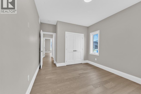 Modern hallway with double doors and hardwood floors - 61 Hilton Court Amherstburg