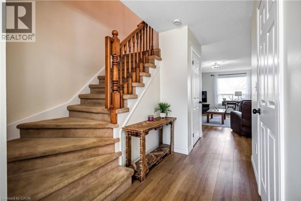 Interior foyer with decorative glass doors and wood flooring - 61 Kendrick Court, Ancaster