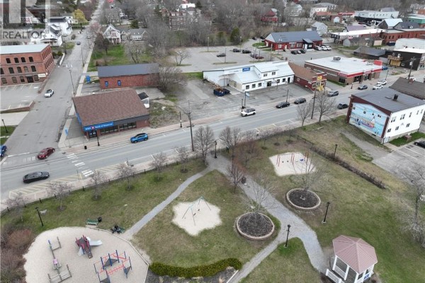 Aerial view of vacant land lot, park with playground, and town. - 61 Milltown Boulevard, St  Stephen