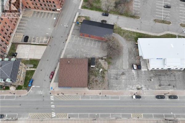Aerial top-down view of vacant land lot with surrounding buildings and road. - 61 Milltown Boulevard, St  Stephen