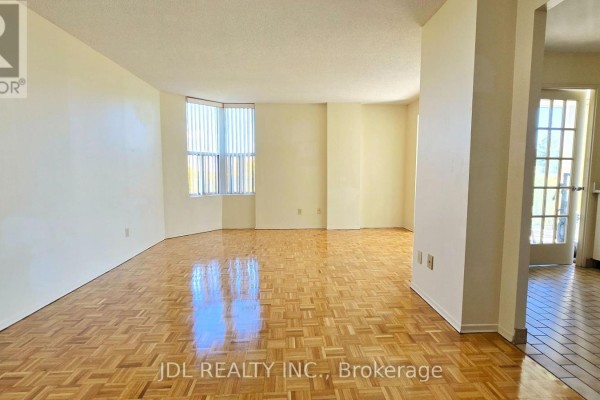 Living room with parquet flooring, large windows, and a view of the entryway. - 610 - 5795 Yonge Street, Toronto