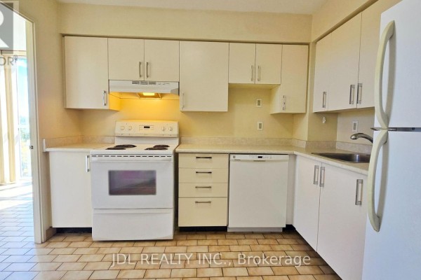 Kitchen with white cabinets, white appliances, and beige tiled floor. - 610 - 5795 Yonge Street, Toronto