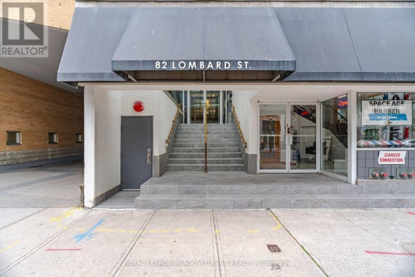 Close-up of the main entrance to 82 Lombard Street with stairs and glass doors. - 610 - 82 Lombard Street, Toronto