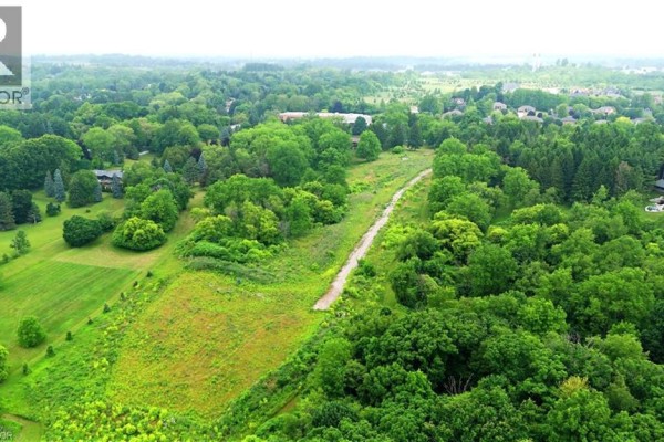 Overhead view of the lush green land with rolling hills and dense forest cover. - 610-612-614 Harvest Road, Flamborough