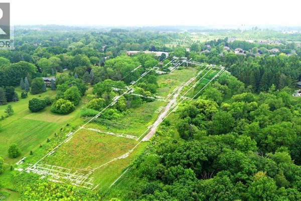 Aerial view of the property with white lines indicating lot boundaries and a dirt road. - 610-612-614 Harvest Road, Flamborough