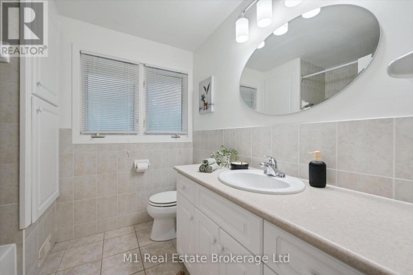 Bathroom with vanity, oval mirror, and toilet - 610 St David Street S Centre Wellington