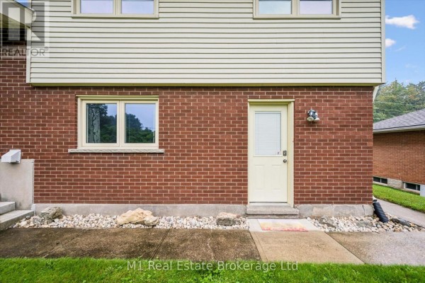 Brick and siding exterior with cream door and window - 610 St David Street S Centre Wellington