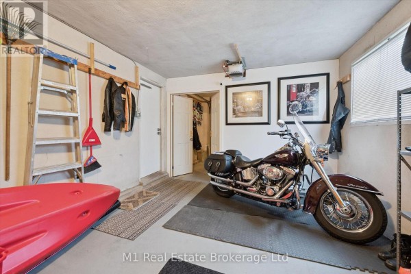 Maroon motorcycle, red kayak, ladder, and motorcycle art - 610 St David Street S Centre Wellington