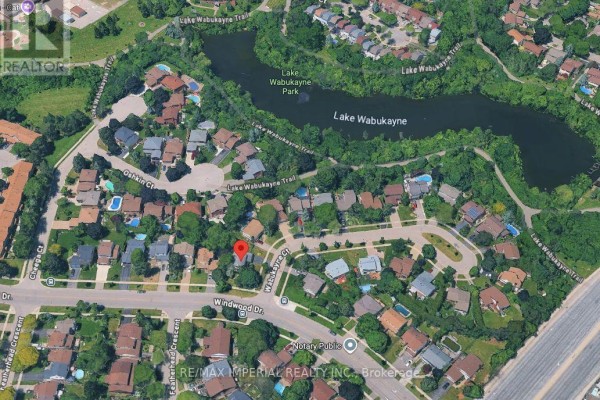 Aerial view of neighborhood showing houses, trees, and Lake Wabukayne Park. - 6100 Wabukayne Court, Mississauga