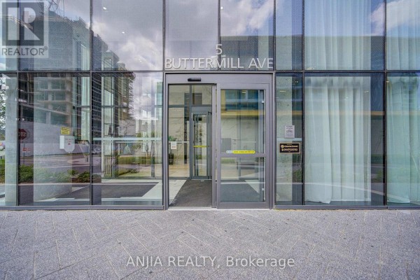 Glass entrance doors with address "5 BUTTERMILL AVE" and brushed metal frame. - 6102 - 5 Buttermill Avenue, Vaughan