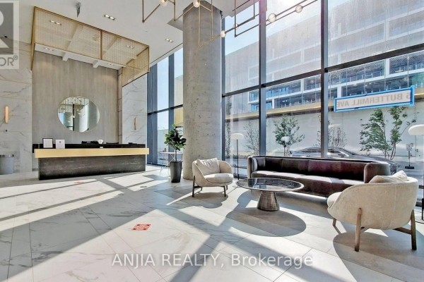 Luxurious lobby with marble floor, reception desk, seating area, and large windows. - 6102 - 5 Buttermill Avenue, Vaughan