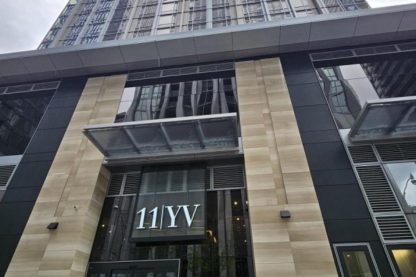 Close-up of the building's entrance with signage "11 YV". - 6105 - 11 Yorkville Avenue, Toronto