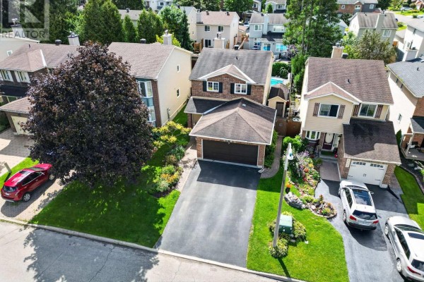Aerial view of a suburban street with houses, garages, and manicured lawns. - 6109 Forestglen Crescent, Ottawa