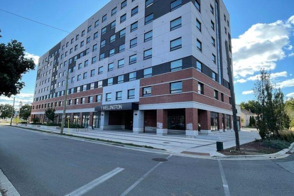 Street view of the apartment building highlighting the entrance and surrounding area. - 611 - 1 Wellington Street, Brantford