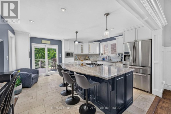 Kitchen island with seating, granite countertops, and stainless steel appliances - 611 Rivermeade Avenue Kingston