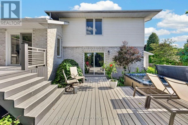 Deck with hot tub and lounge chairs - 611 Rivermeade Avenue Kingston