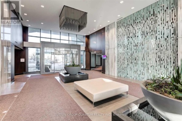 Building lobby featuring floor-to-ceiling windows, modern seating, and decorative wall panels. - 612 - 205 Sherway Gardens Road, Toronto