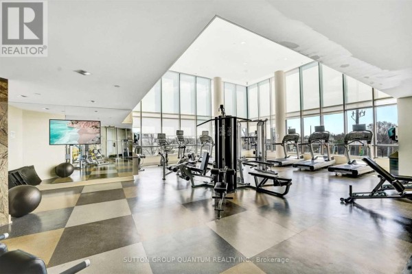 Bright fitness center with treadmills, weight machines, and large windows overlooking trees. - 612 - 205 Sherway Gardens Road, Toronto
