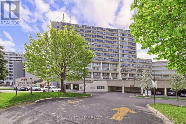 Street view of the 5580 Sheppard Place Condominium building with green trees and blue sky. - 613 - 5580 Sheppard E Avenue, Toronto
