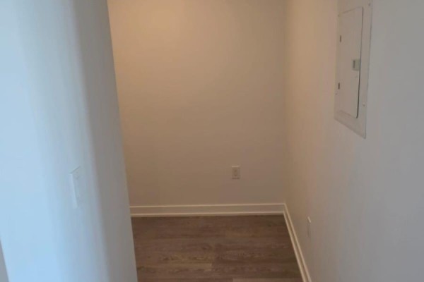 Empty hallway or closet space with light wood-look flooring and white walls. - 614 - 740 Whitlock Avenue, Milton