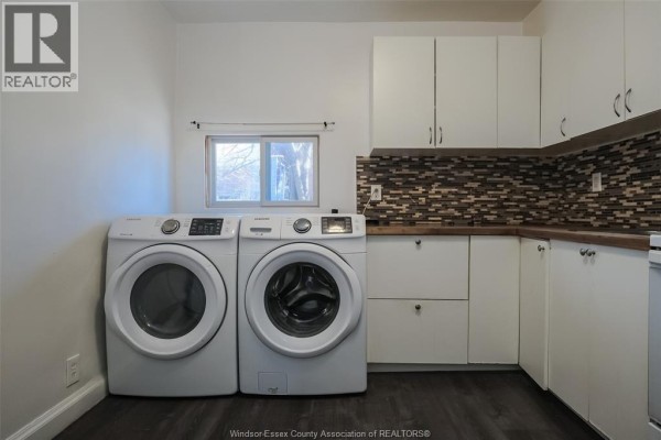 Kitchen featuring white cabinets, wood countertops, and mosaic backsplash - 614 Elliott Street East, Windsor