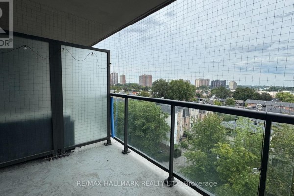 View of Toronto neighborhood with apartment buildings and green trees. - 615 - 8 Trent Avenue, Toronto