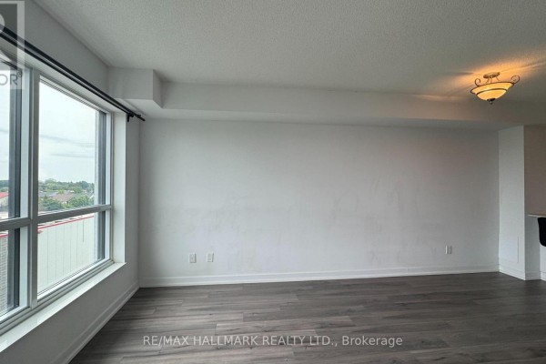 Balcony with wooden flooring, chairs, plants, and city view. - 615 - 8 Trent Avenue, Toronto