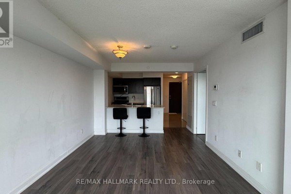Dining area with small table, chairs, and large window with city view. - 615 - 8 Trent Avenue, Toronto