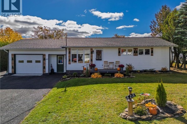 Front exterior of a white bungalow with a covered porch. - 615 5th Avenue, Grand Sault/grand Falls