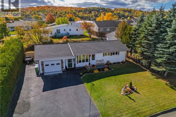 Aerial view of a white bungalow on a green lot. - 615 5th Avenue, Grand Sault/grand Falls