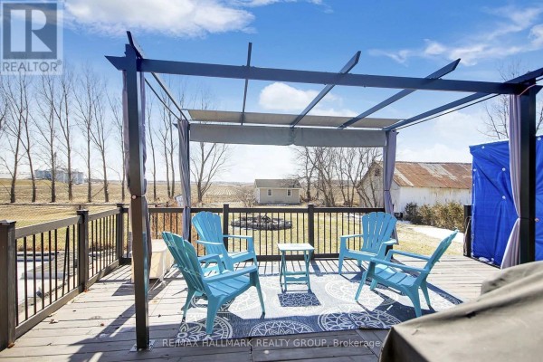 Deck with pergola, chairs, rug, and rural view - 6151 Malakoff Road Ottawa