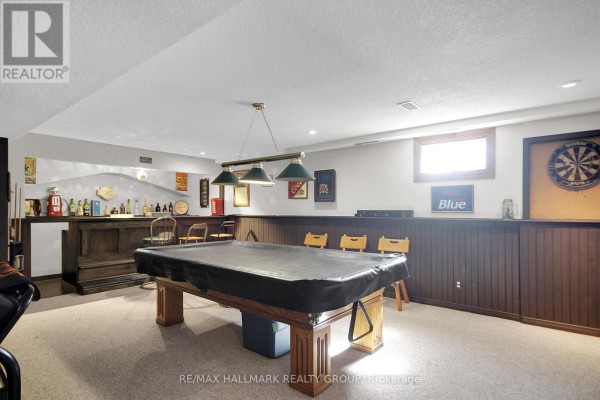 Basement with pool table, bar, dartboard, and vintage decor - 6151 Malakoff Road Ottawa
