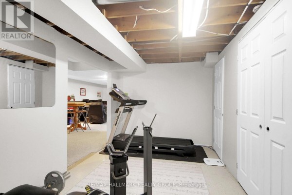 Basement gym area with treadmill, weight bench, and dining area - 6151 Malakoff Road Ottawa